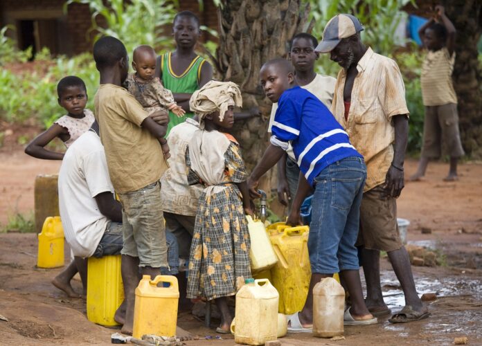 Village life Locals gather around for water collection.